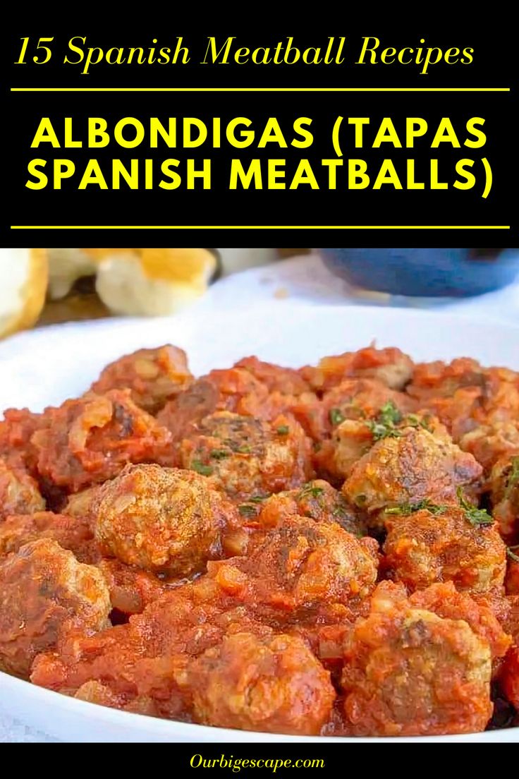 a white plate topped with meatballs covered in sauce