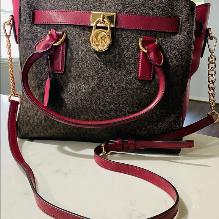 Michael Kors Hamilton Colorblock Signature Brown/Mulberry I Have Carried It Twice Maybe 3 Times Purchased Used From Another Online Retailer. Just Sitting In My Closet. Colors Are Brown/Mulberry With Gold Hardware. Thanks For Looking! (Mulberry- Dark Red, Burgandy, Maroon, Wine Color Type) *12-3/4" W X 9" H X 5-1/2" D * Interior Features Zip Pocket, 2 Slip Pockets And Key Fob * 5"L Double Handles; Adjustable Chain/Leather Shoulder Strap *Zip Top Closure * Exterior Features A Signature Key And Lock * Gold-Tone Hardware *Signature Mk Monogram Logo *Saffiano Leather Michael Kors Handbags Black, Mk Monogram, Key And Lock, Studded Handbag, Closet Colors, Michael Kors Mercer, Michael Kors Satchel, Tan Handbags, Black Satchel