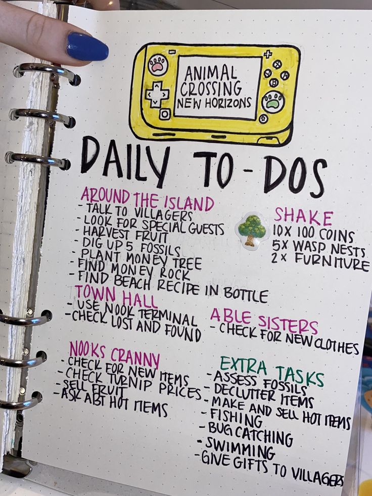 a hand holding a notebook with an animal crossing new horizon daily to do list on it