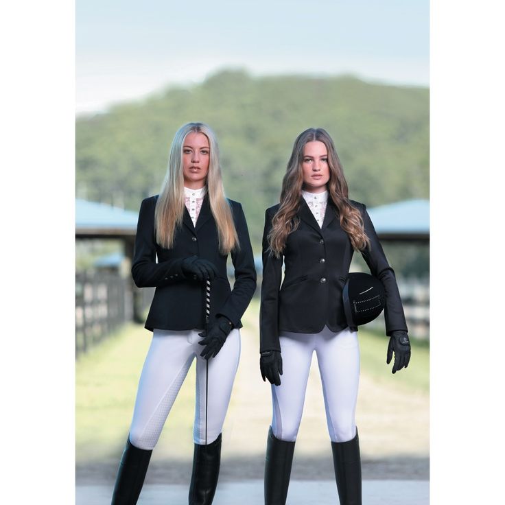 two women in riding gear standing next to each other