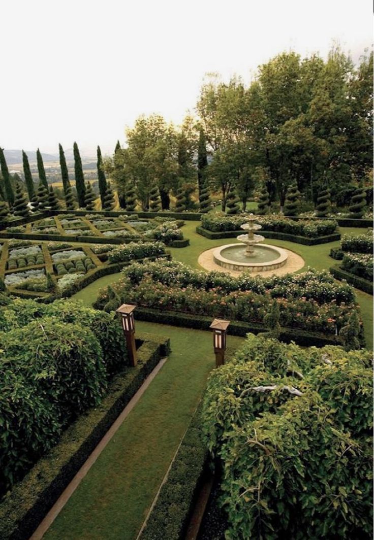 a formal garden is shown in the middle of an area with many hedges and trees