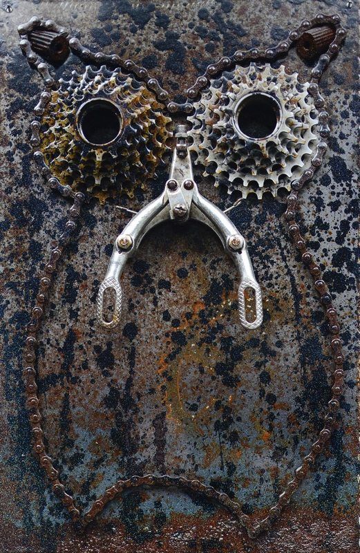 a close up of a pair of scissors on a rusted metal surface with holes in the middle