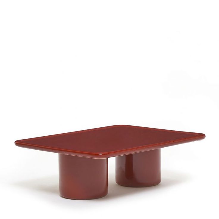 a red table sitting on top of a white floor