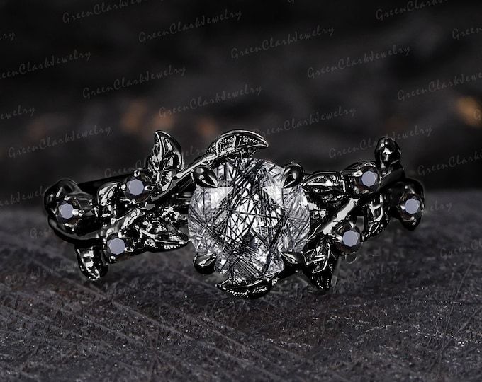 an intricately designed ring with white stones on it's center and leaves in the middle