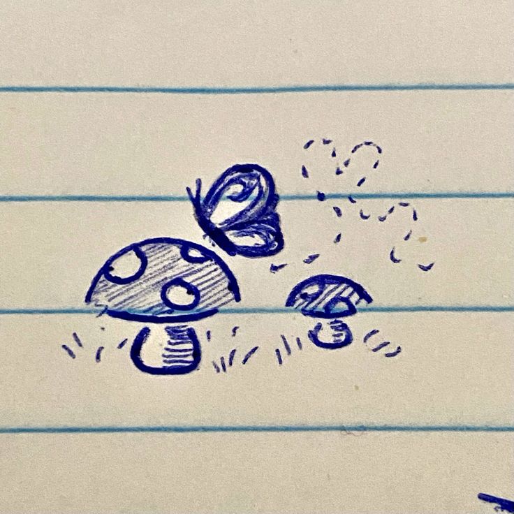 a pencil drawing of two mushrooms and a butterfly on lined paper with blue marker markers