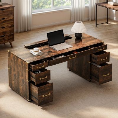 a wooden desk with drawers and a laptop on it in front of a large window