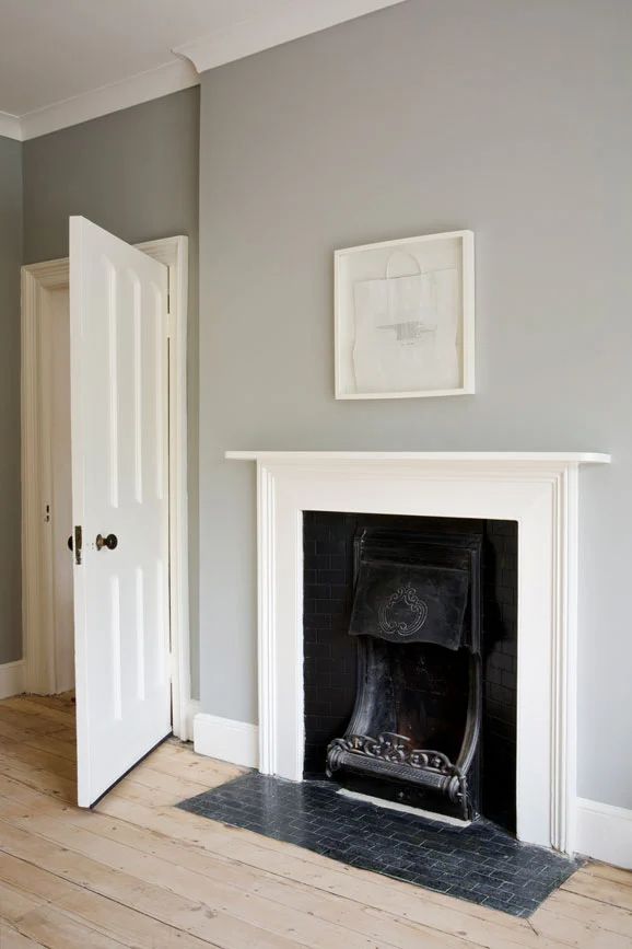 an image of a living room with fireplace and gray walls on the phone call us today