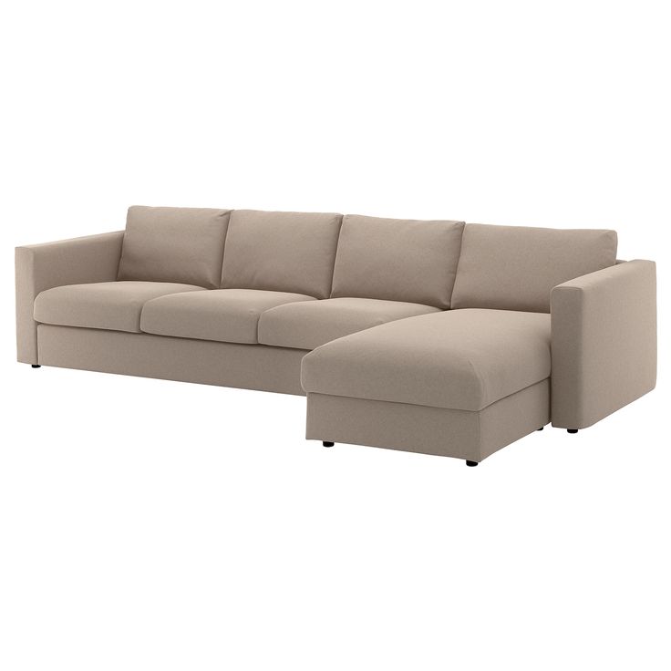 a beige sectional couch sitting on top of a white floor