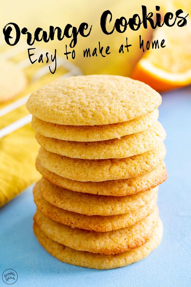 orange cookies stacked on top of each other in front of an orange and blue background