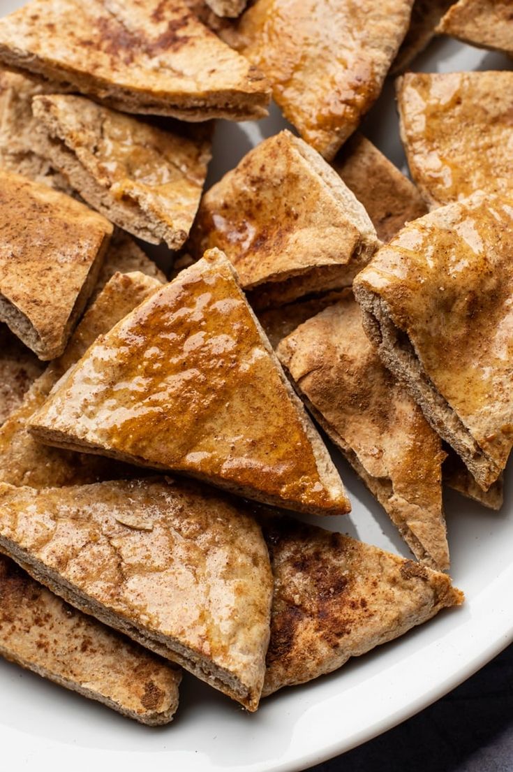 a white plate topped with cut up pieces of cinnamon sugar pie crusted pastries