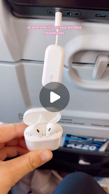 someone is holding their ear buds in front of the air conditioner on an airplane