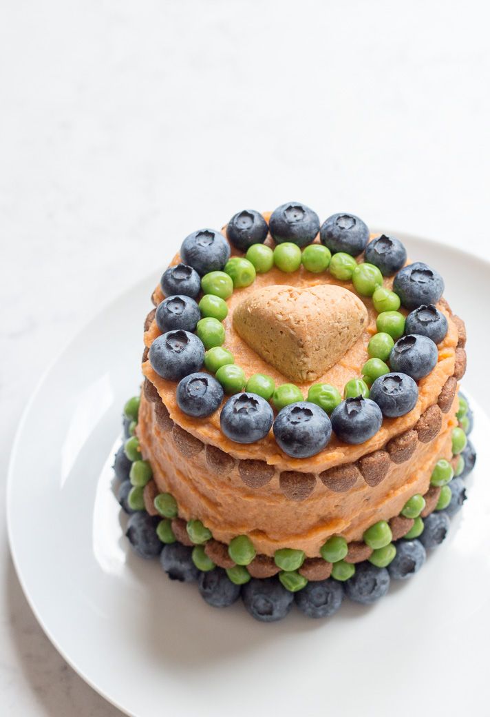 a cake with blueberries, green peas and a heart on top