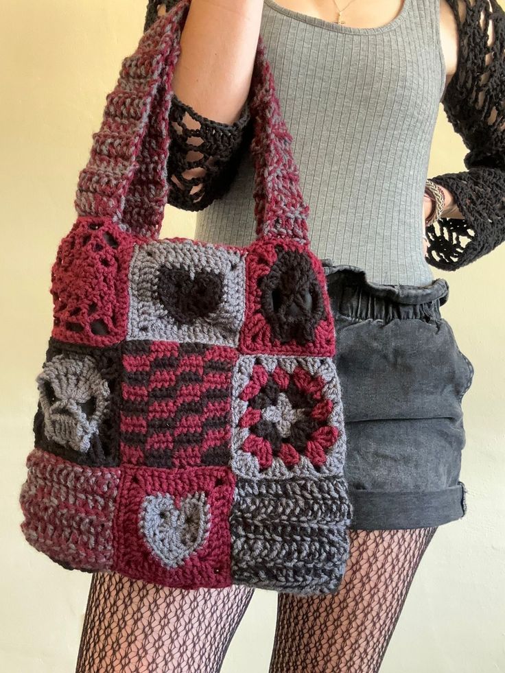 a woman is holding a crocheted bag in front of her face while wearing tights and stockings