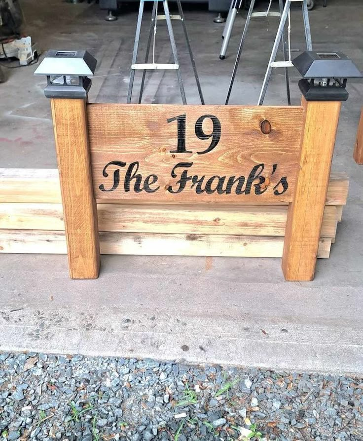 a wooden sign that says 19 the frank's on it and some chairs behind it