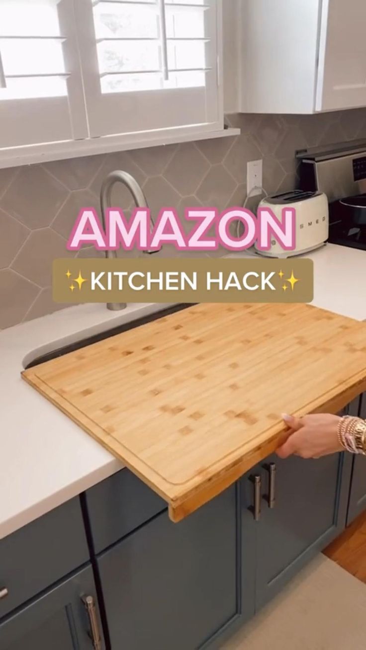 a woman standing in front of a wooden cutting board on top of a kitchen counter