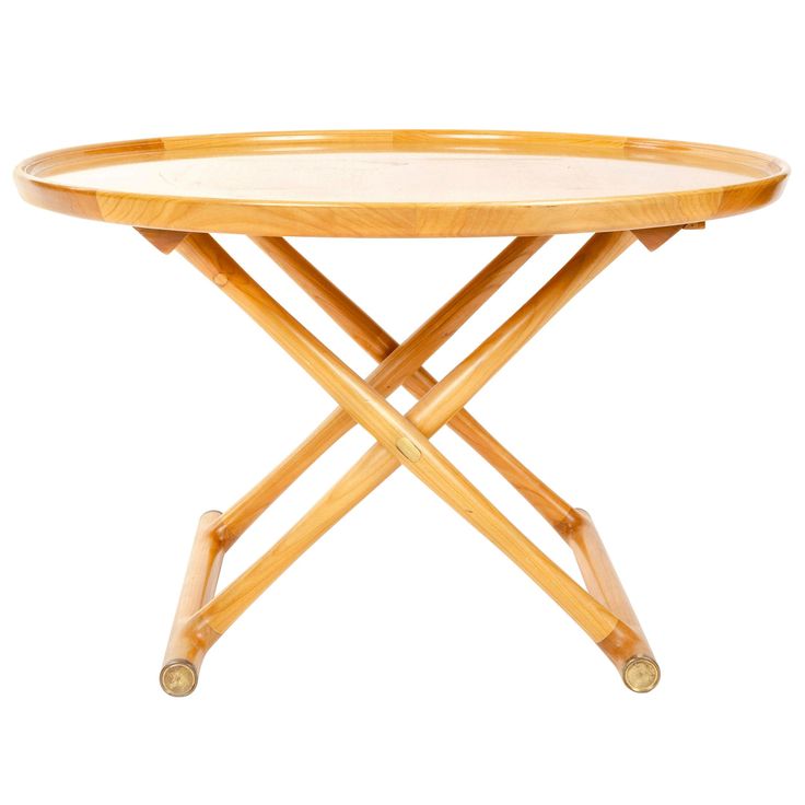 a small wooden table with wheels on the legs and a round tray underneath it that has been turned into a coffee table