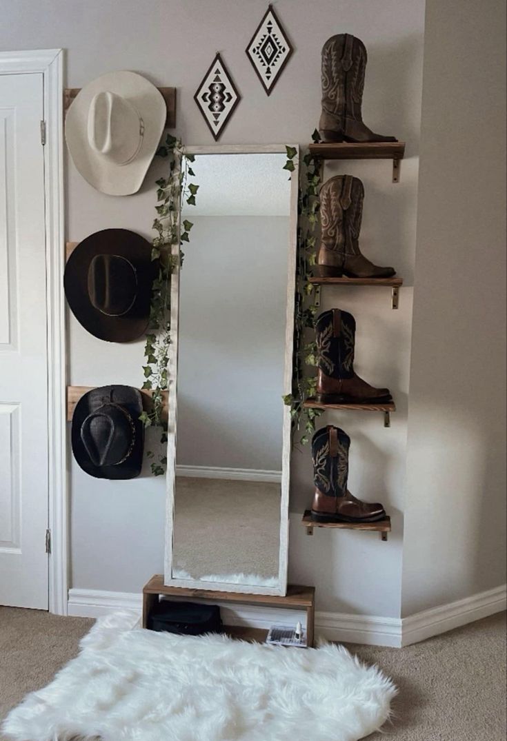 a white mirror sitting on top of a wooden shelf next to a wall mounted hat rack