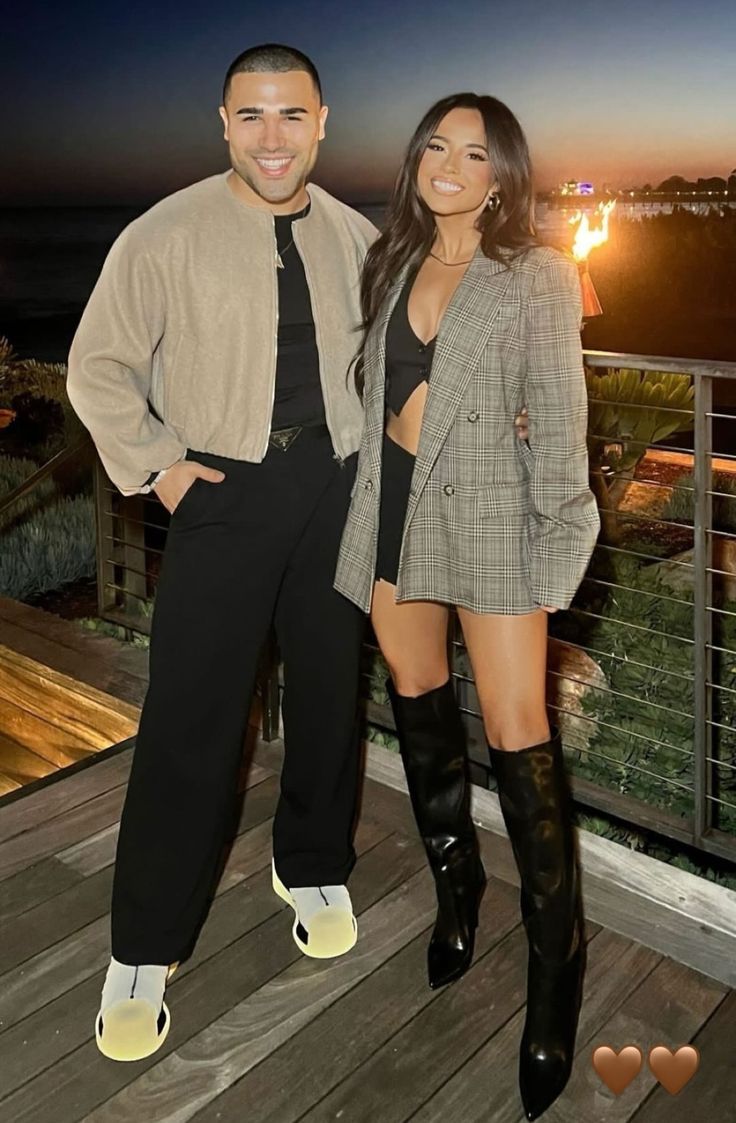 two people standing on a deck at night