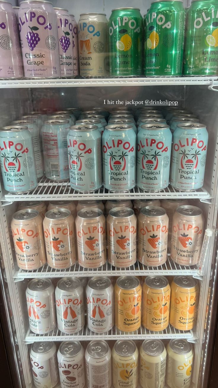 a refrigerator filled with lots of different types of sodas and soft drinks in cans