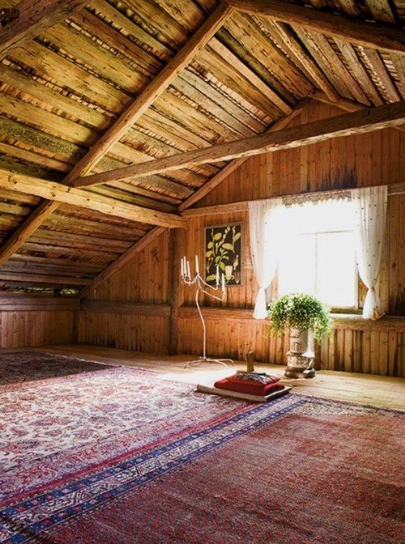 a room with wood paneling and a rug on the floor in front of a window