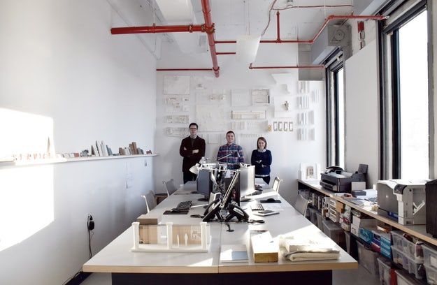 two people are standing in an office