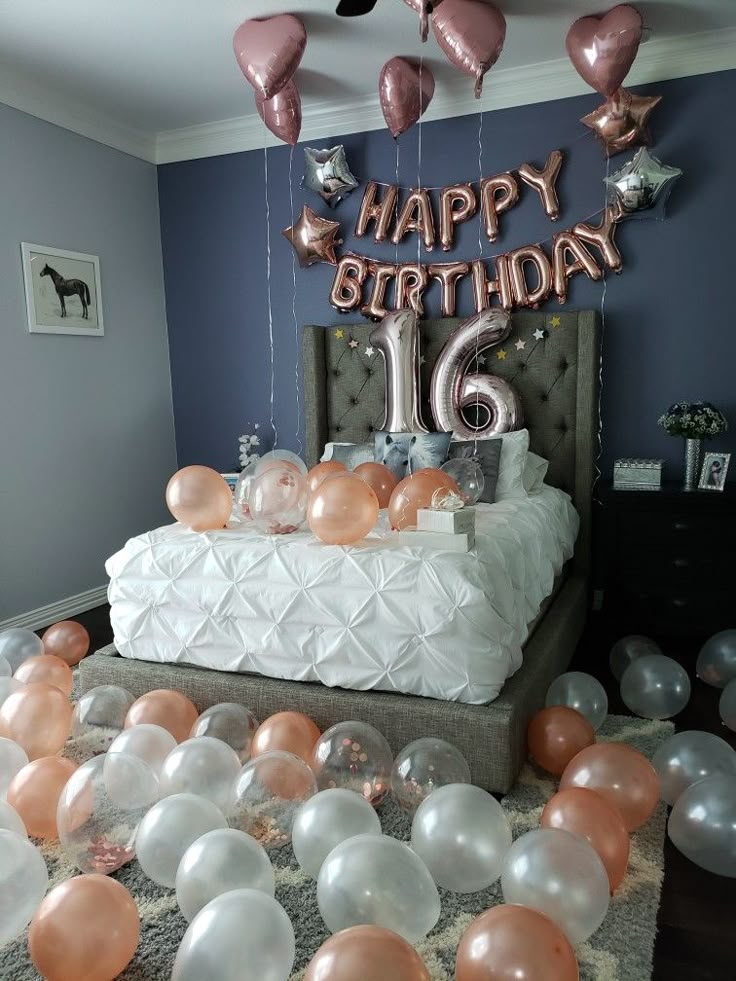 a birthday bed with balloons and streamers in the air