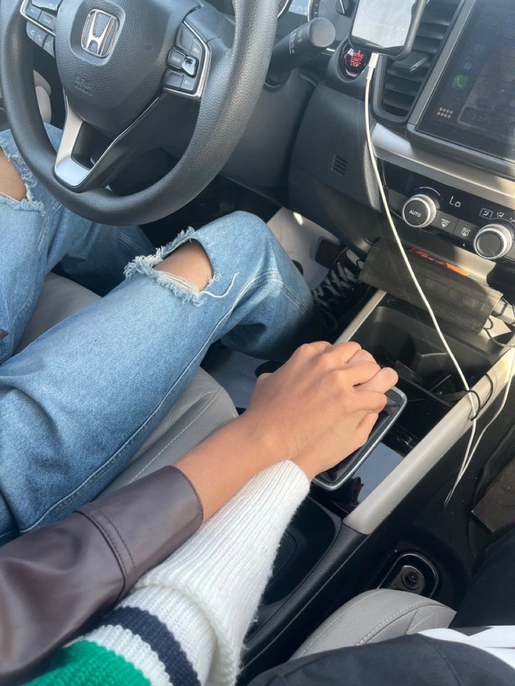 a person sitting in the driver's seat of a car