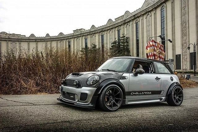 a small car parked in front of a building