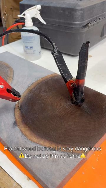 a piece of wood being cut with scissors and glue on top of it in front of a tool box