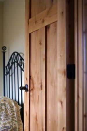 an open door to a bedroom with a bed in the background