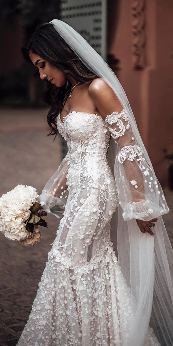 a woman in a wedding dress holding a bouquet