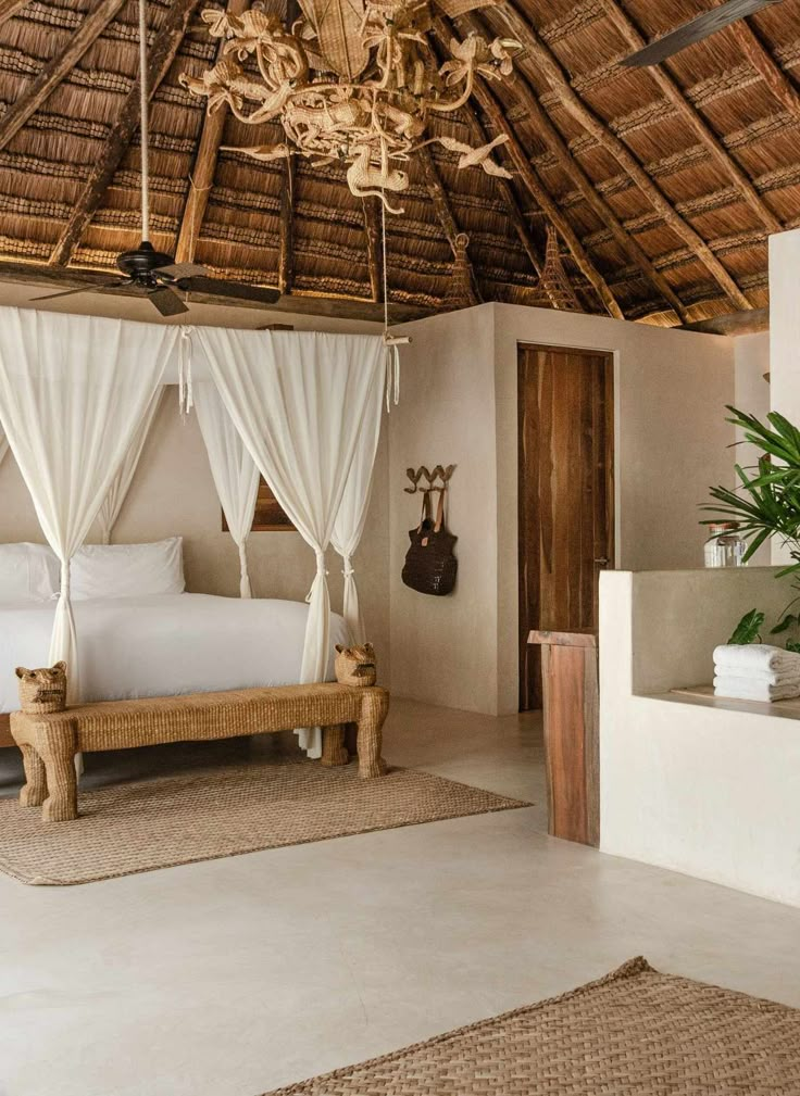 a bed sitting under a wooden roof in a bedroom