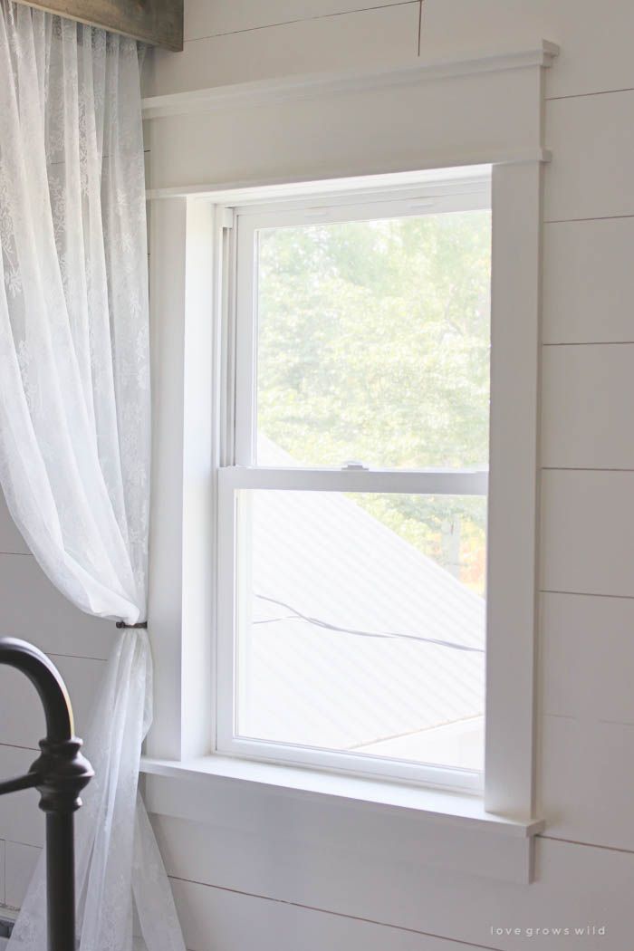 a window with sheer curtains in a white room