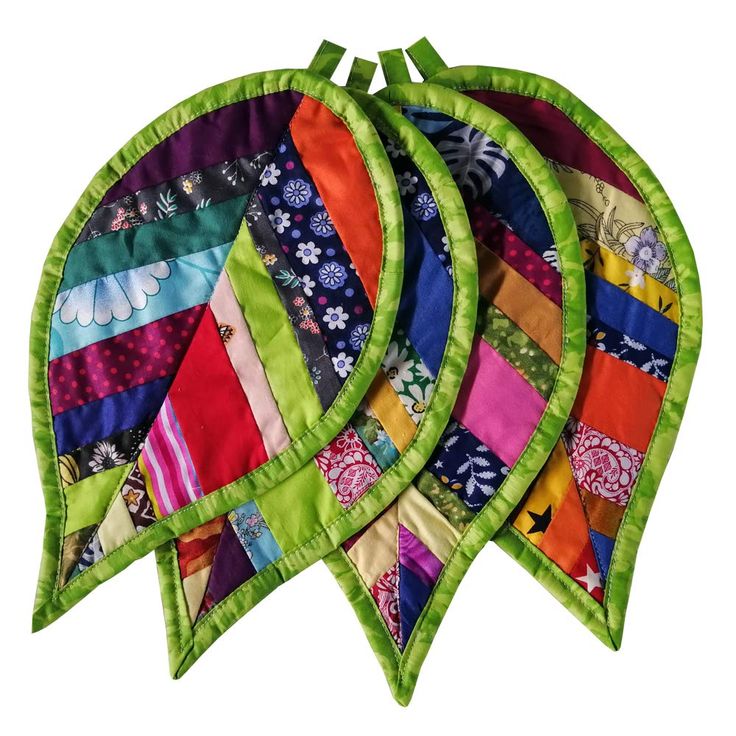 four pieces of colorful quilted fabric on top of each other