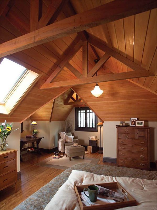 an attic bedroom with wood paneling and vaulted ceiling