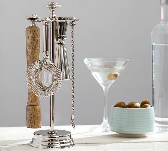 an assortment of wine accessories on a table next to a martini glass and bottle opener