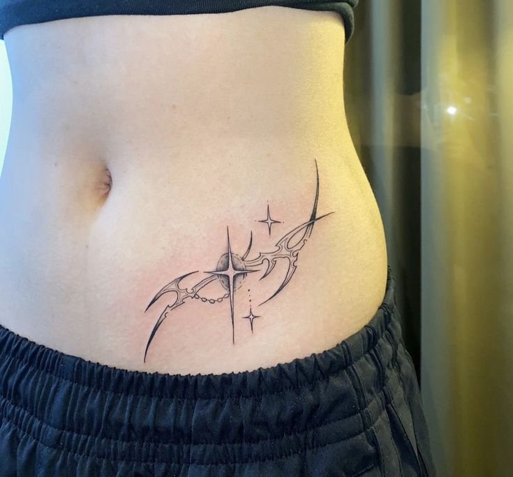 a woman's stomach with a cross tattoo on the side and an arrow in the middle