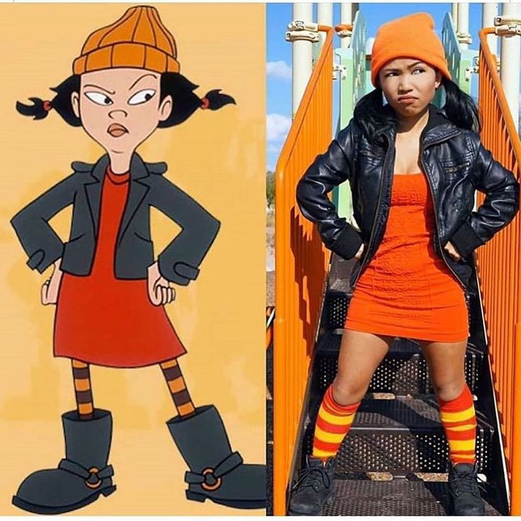 a woman in an orange dress and black jacket standing next to a cartoon character with her hands on her hips