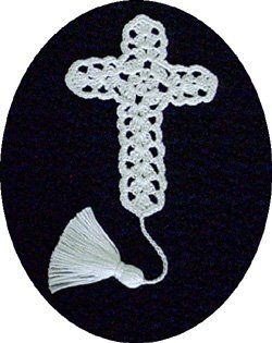 a crocheted cross and tassel on a black circle