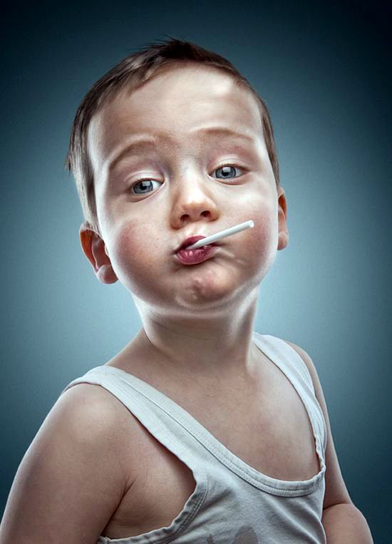 a young boy is making a funny face with an electronic toothbrush in his mouth