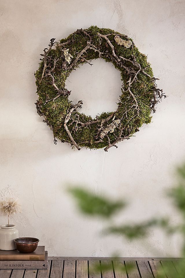 a mossy wreath hanging on the wall