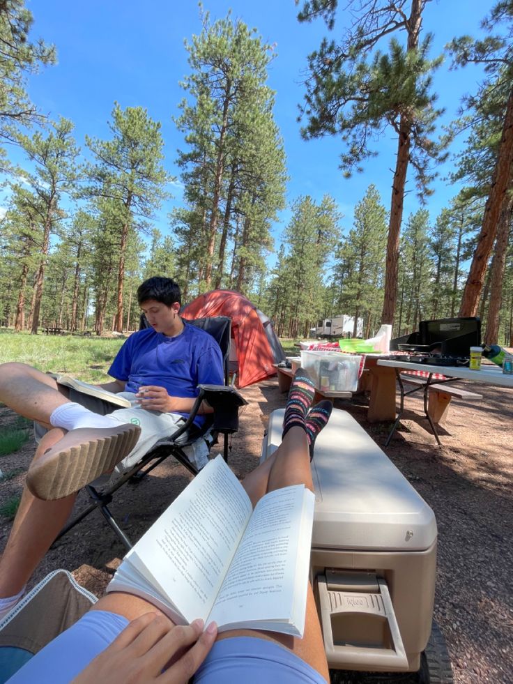 a man sitting in a chair reading a book