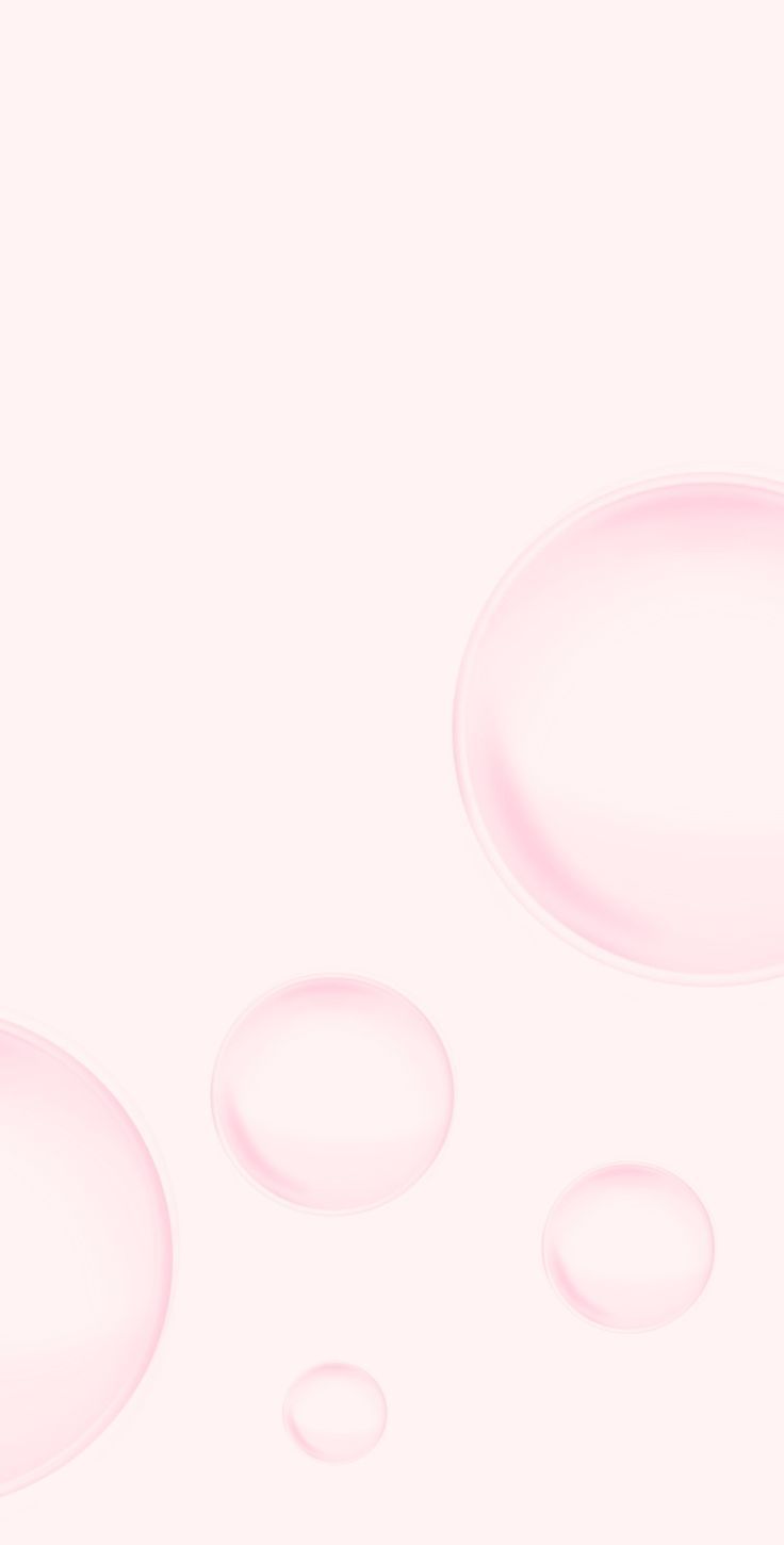 three bubbles are floating in the air on a pink and white background that appears to be liquid