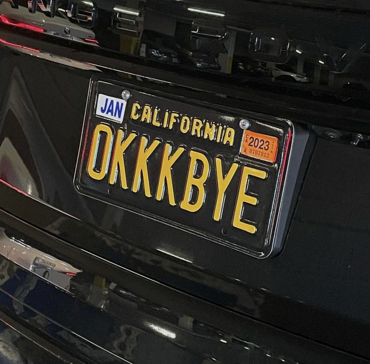 the license plate for an automobile is displayed in front of a vehicle's grill