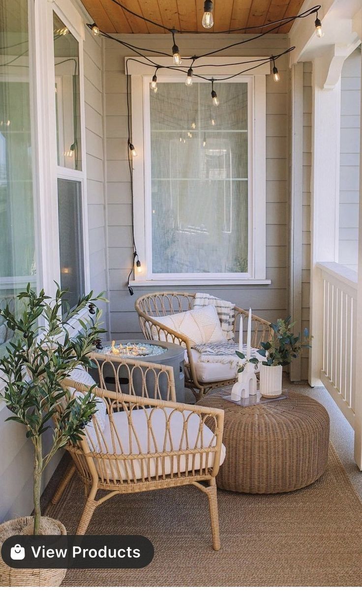 the porch is decorated with wicker furniture and string lights