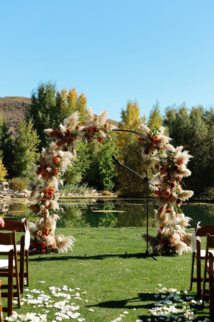 an outdoor ceremony setup with chairs and flowers