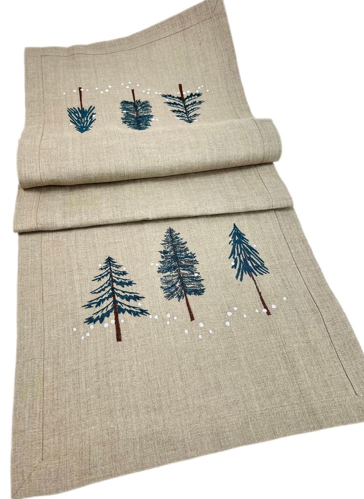 two pieces of fabric with trees on them