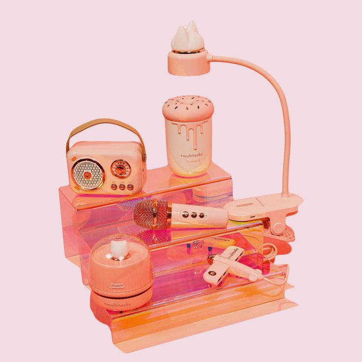 an assortment of beauty products displayed on a pink shelf with a white light in the background