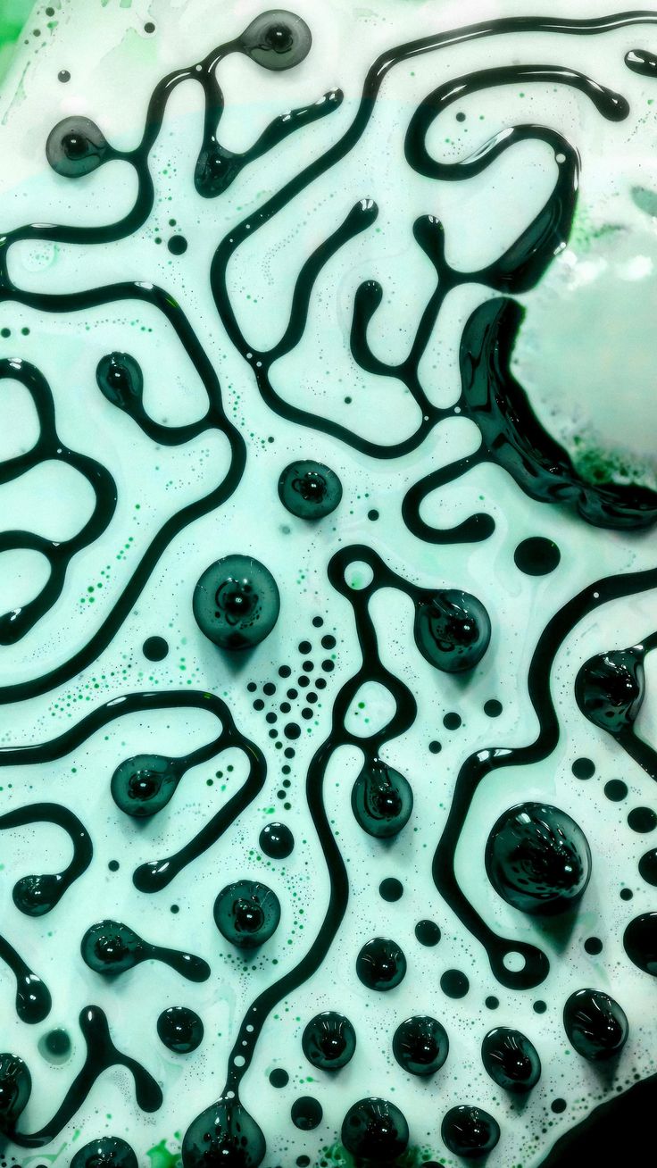 an abstract painting with black and green paint on it's surface, in the shape of a flower