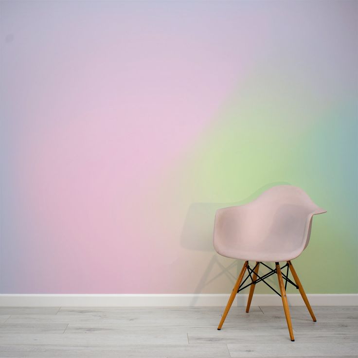 a white chair against a pastel colored wall